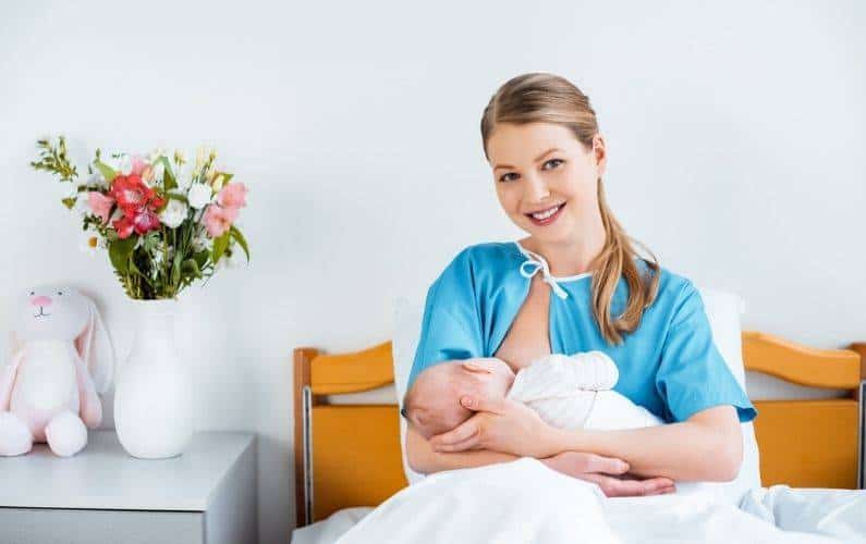 new mom in the hospital holding her newborn baby