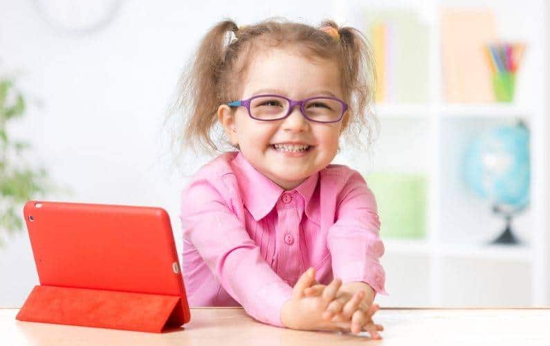 little girl wearing glasses with a red tablet