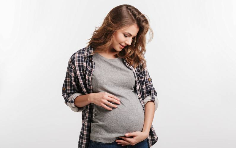 pregnant woman holding her belly