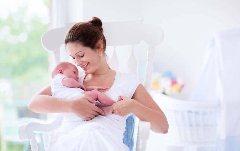 new mom holding baby while on her maternity leave